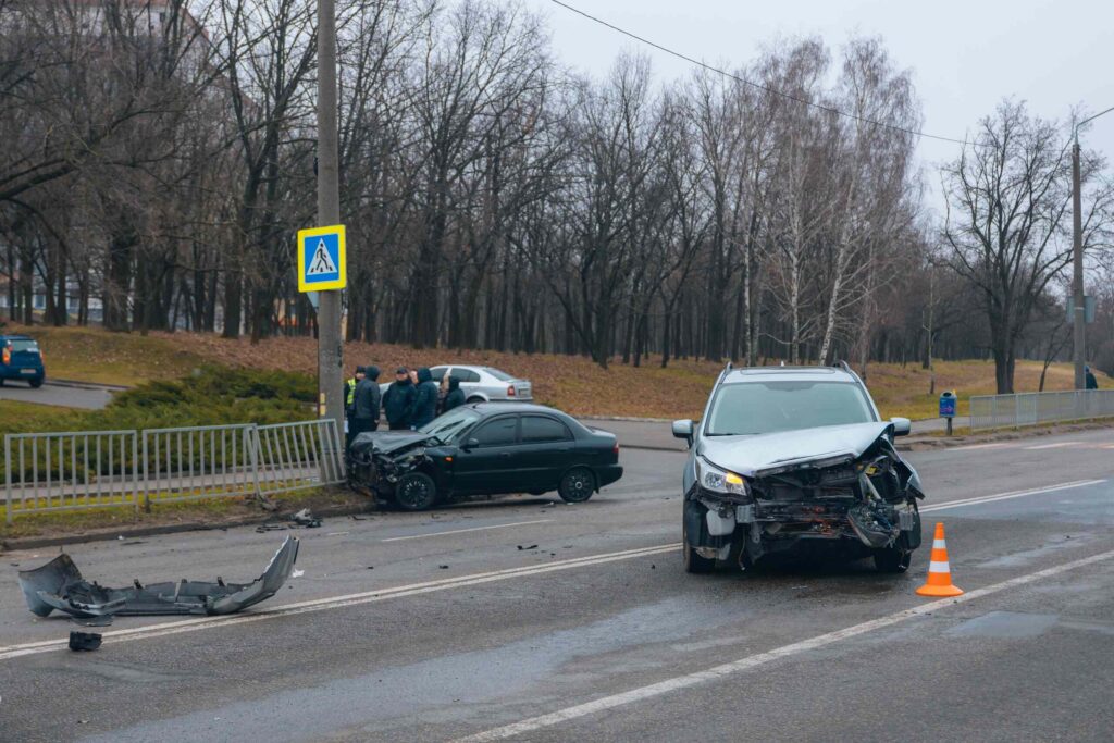 Multi-vehicle car accident scene on a Michigan roadway with damaged vehicles, illustrating how fault is determined in Michigan car accidents.
