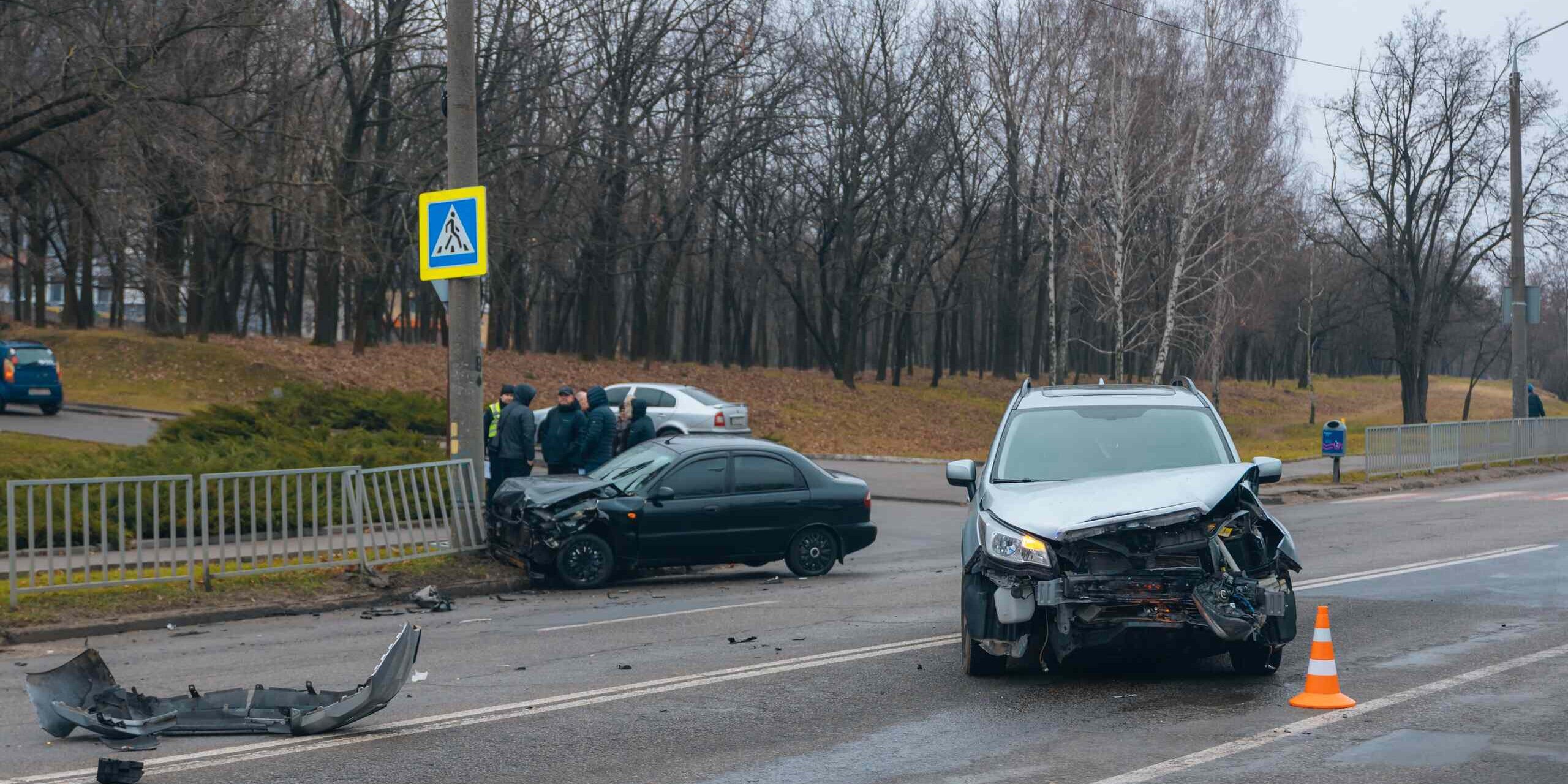 Multi-vehicle car accident scene on a Michigan roadway with damaged vehicles, illustrating how fault is determined in Michigan car accidents.