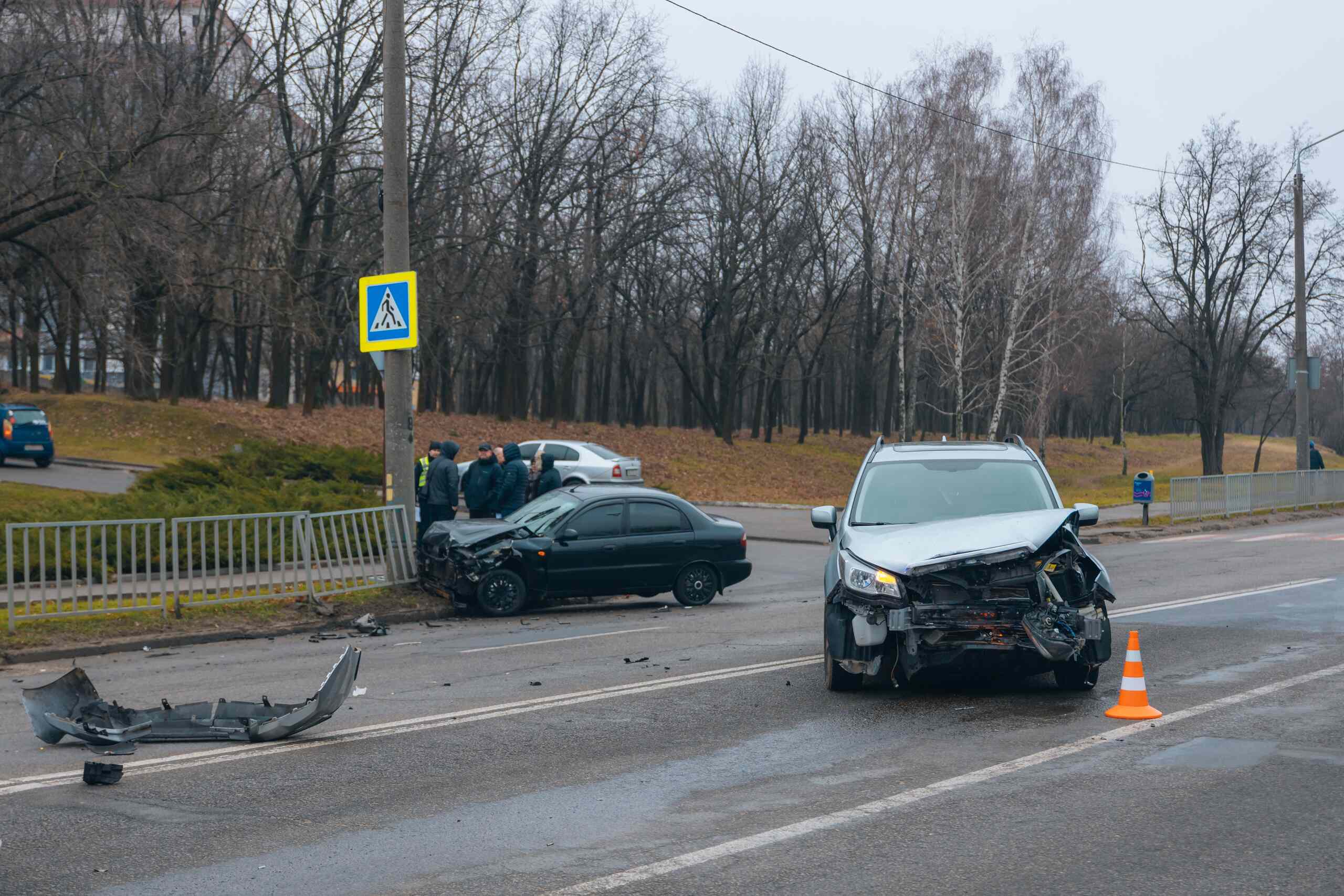 Multi-vehicle car accident scene on a Michigan roadway with damaged vehicles, illustrating how fault is determined in Michigan car accidents.