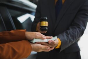 Michigan car accident lawyer image of legal settlement concept with judge gavel and cash exchange after a car crash