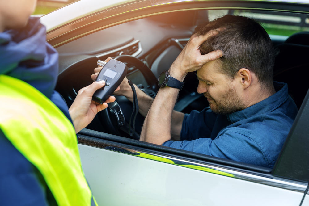 Oak Park drunk driving accident lawyer image of driver being tested with breathalyzer after suspected DUI crash