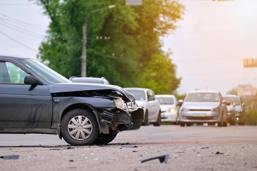 Michigan motorcycle accident lawyer image of damaged car after crash on road