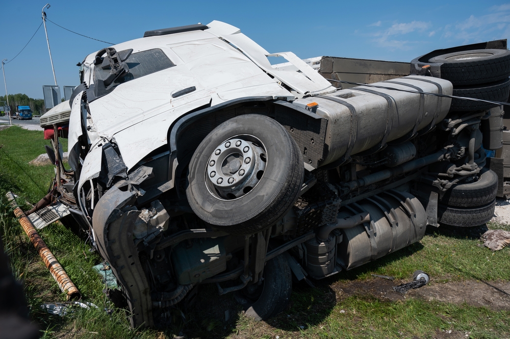 Overturned semi truck crash on roadside showing severe damage relevant to Oak Park truck accident lawyer