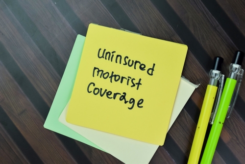 Michigan personal injury lawyer image of uninsured motorist coverage note showing insurance protection concept