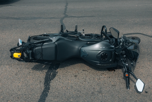 Michigan motorcycle accident lawyer image of fallen motorcycle on road after crash