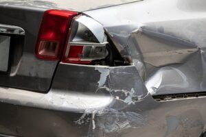 Michigan car accident lawyer image of rear end collision damage on vehicle bumper
