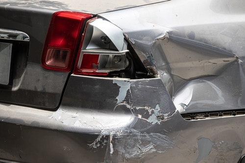 Michigan car accident lawyer image of rear end collision damage on vehicle bumper
