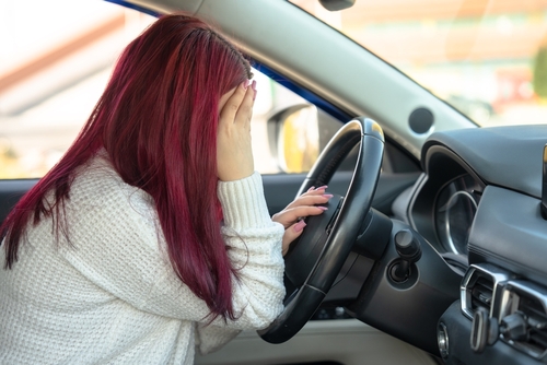 Michigan car accident lawyer police report image of driver showing stress after crash inside vehicle