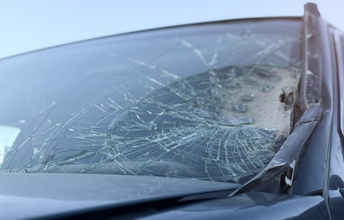 Michigan car accident lawyer image of severely cracked windshield from a vehicle collision showing crash damage evidence